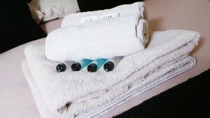 A white towel with a label reading "LUX" on a person's arm.