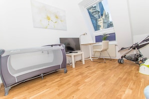 Enjoy a compact room with a desk, chair, and large window offering a view of a historic building.