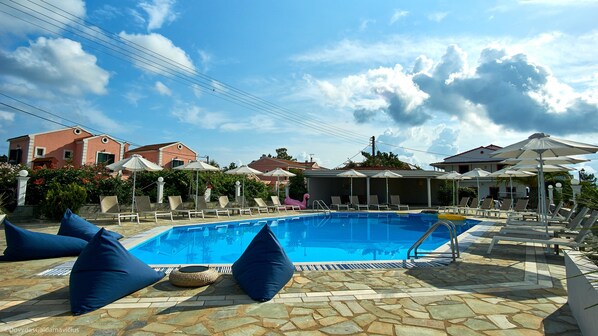 Outdoor pool, open 9:00 AM to 8:00 PM, pool umbrellas, pool loungers