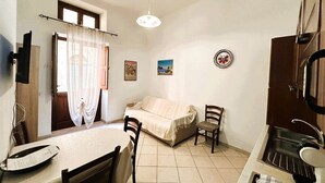 Departamento, Terraza, vista parcial al mar | Área de sala de estar | Televisión de pantalla plana de 24 pulgadas con canales por cable