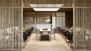 A modern dining area with bamboo partitions, wooden tables, and black chairs. - Olea All Suite Hotel, a Member of Design Hotels (Zakynthos)