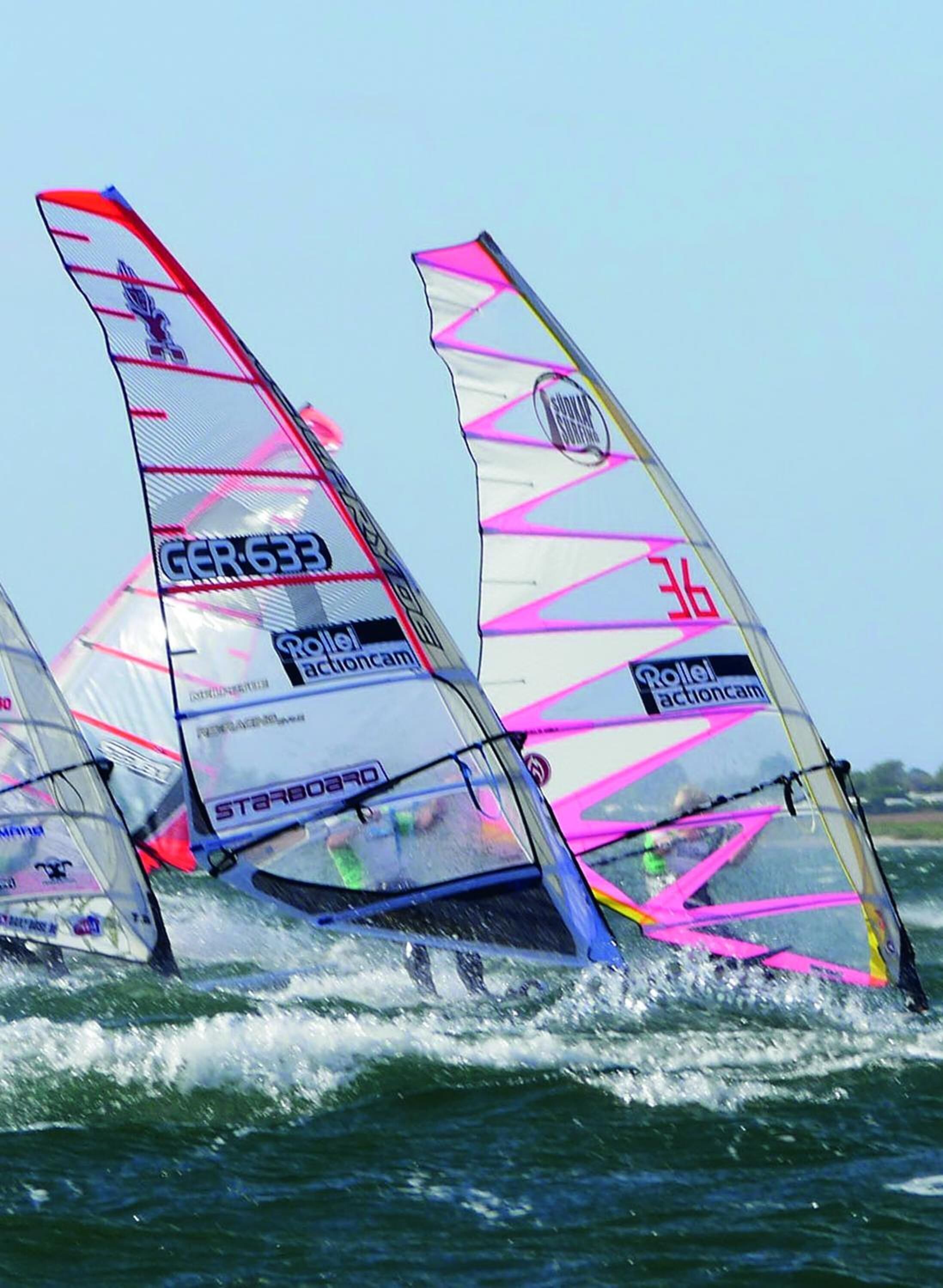 A sailboat with multiple sails, each marked with "Roller Actioncam" and "Starboard" text.
