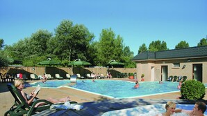Et poolområde med liggestole og jacuzzi.