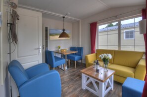 Premium House, 2 Bedrooms | Living area | Flat-screen TV, pay films - Ferienwohnungen Wulfener Hals (Fehmarn)