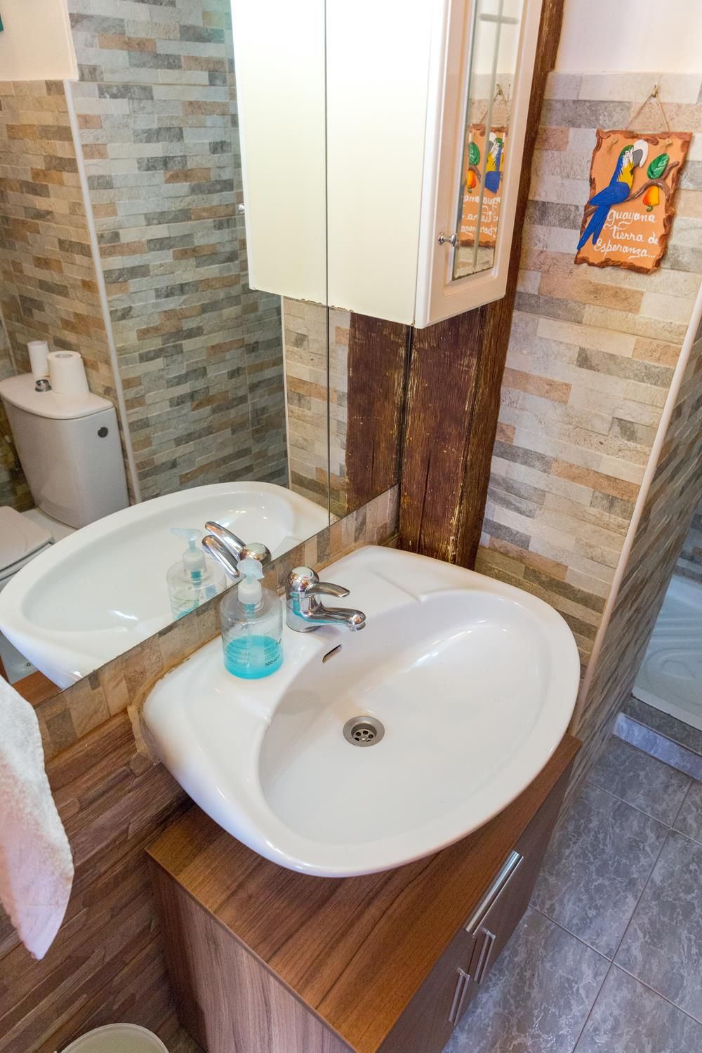 A bathroom with two sinks, a mirror, and a towel rack.
