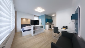 A modern apartment with a living room, a kitchen, and a dining area. - Appartments Drei Morgen (Leinfelden-Echterdingen)