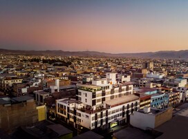 Un hotel con varios pisos, techo plano y un cartel que indica que es un hotel.