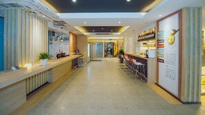 Un hall d’hôtel comprenant un comptoir d’accueil, un espace salon et un bar.
