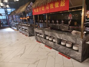 A restaurant interior with marble counters and thatched roofs.