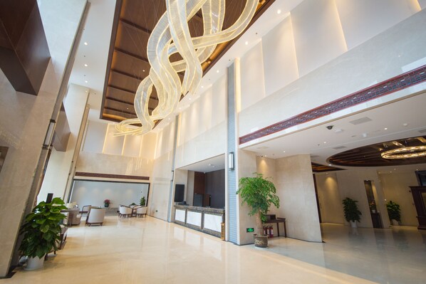 A spacious lobby with a modern chandelier, seating areas, and potted plants. - ibis Styles Nanjing Qilin Gate Hotel (Nanjing)