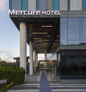 A modern hotel entrance with a clear pathway leading to the entrance, large pillars, and a sign reading "Mercure HOTEL". - Mercure Istanbul Umraniye (Istanbul)