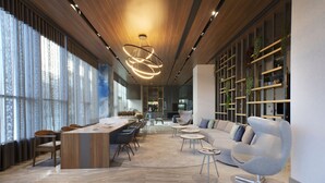 Een modern interieur met een eethoek, banken en een boekenplank.