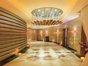 A modern hallway with a marble floor, a unique ceiling light fixture, and a decorative wall panel. - Mercure Istanbul Umraniye (Istanbul)