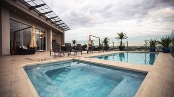 Outdoor pool, open 10:00 AM to 10:00 PM, pool loungers