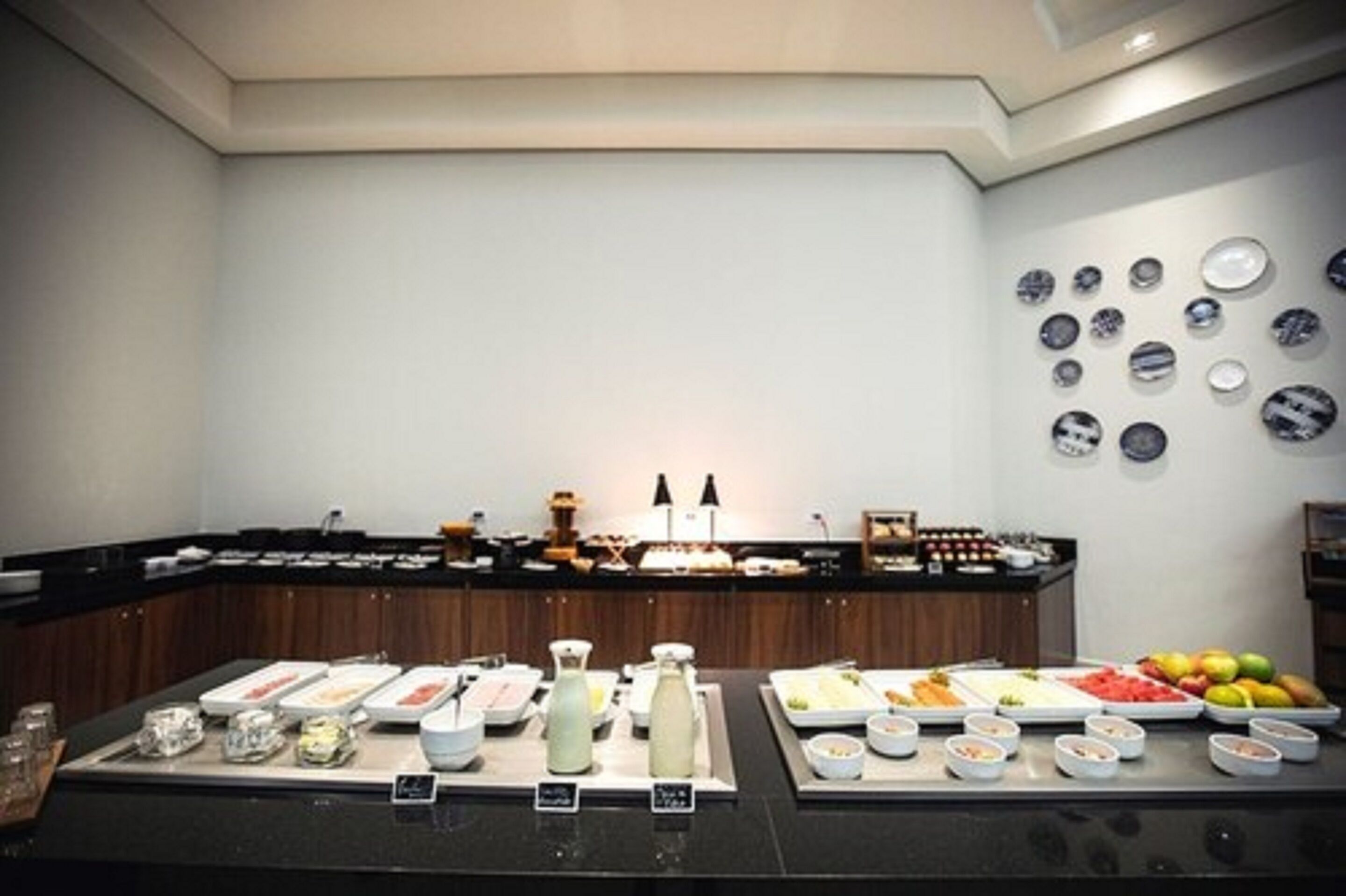 A buffet setup with various food items and beverages.