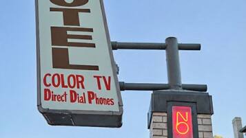 A motel sign with "Crest Motel" and "Color TV Direct Dial Phones" advertised.