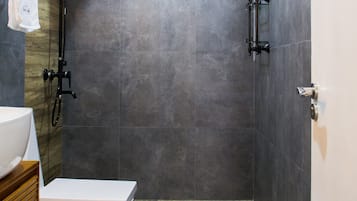 A modern bathroom with a shower, toilet, and sink.
