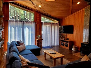 Relax in this inviting living room with a comfortable sofa, flat-screen TV, and fireplace.
