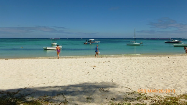A sandy beach with several boats anchored in the water. - Villa Alexis Self-Catering (Trou aux Biches)