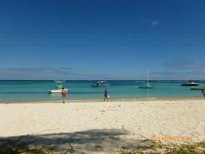 A sandy beach with several boats anchored in the water. - Villa Alexis Self-Catering (Trou aux Biches)