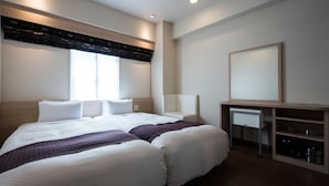 A modern hotel room with a large bed, bedside tables, a mirror, and a built-in TV. - Nagasaki Bus Terminal Hotel (Nagasaki)