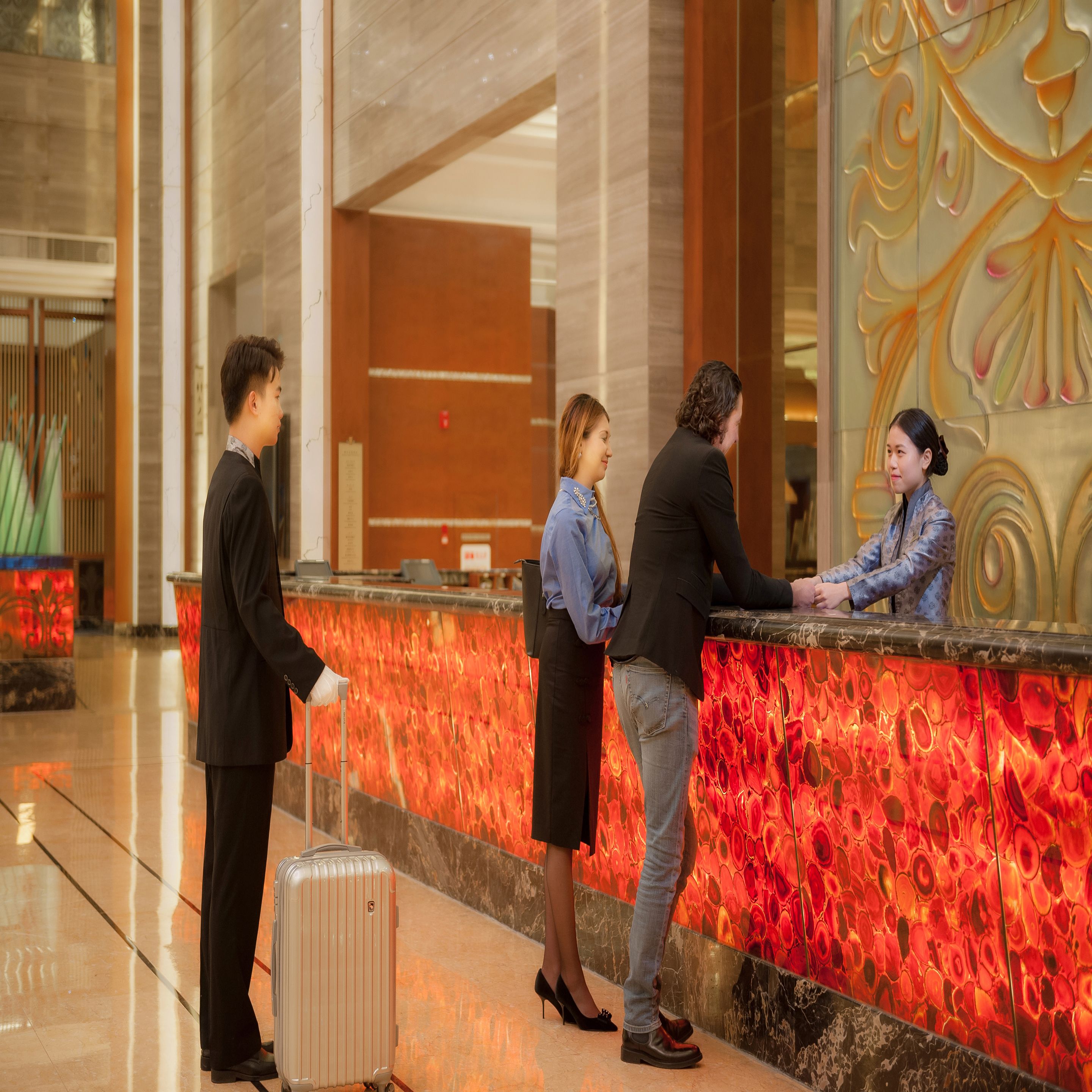 A reception area with a marble counter, a reception desk, and a modern interior design.