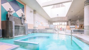 A swimming pool with a waterfall feature, a tiled floor, and a mural on the wall. - Yokkaichionsen Ofurocafe Yumoriza (Yokkaichi)