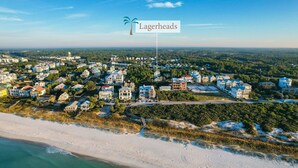 An aerial view of a coastal residential area with houses, a beach, and a sign labeled "Lagerheads". - Lagerheads (Panama City Beach)