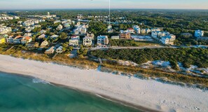 An aerial view of a coastal residential area with houses, a beach, and a sign labeled "Lagerheads".