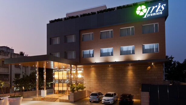 A hotel with a modern design, featuring a prominent logo on the facade. - Iris Premire (Ahmednagar)