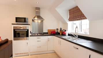 Deluxe Apartment, 2 Bedrooms | Private kitchen | Fridge, microwave, coffee/tea maker, cookware/dishes/utensils