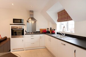 Deluxe Apartment, 2 Bedrooms | Private kitchen | Fridge, microwave, coffee/tea maker, electric kettle