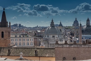 A cityscape with historical architecture, including domed buildings and a prominent tower.