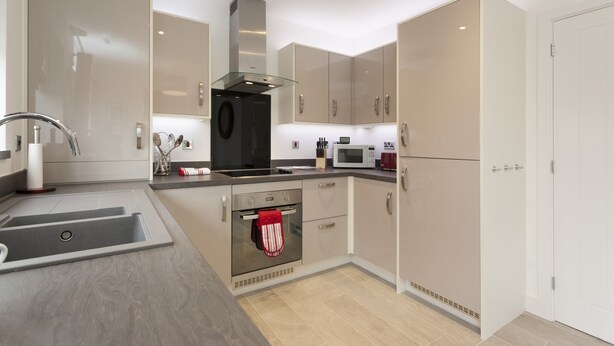 A modern kitchen with stainless steel appliances, a built-in oven, and a microwave. - The Mews (Derby)