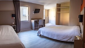 A hotel room with two beds, a desk with a chair, a TV mounted on the wall, and a wardrobe. - Hotel de la Gare – urban by balladins (Chateauroux)