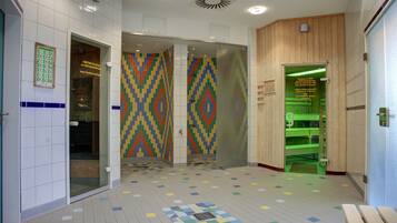 Clean and well-maintained restroom with modern design, featuring a geometric patterned floor and colorful tile walls.