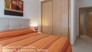 Quarto com cama, mesa de cabeceira, abajur, guarda-roupa e um quadro na parede.