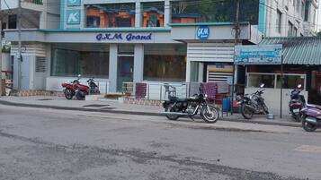 A building with the sign 'G.K.M Grand' and a KLM logo, indicating it is a hotel.