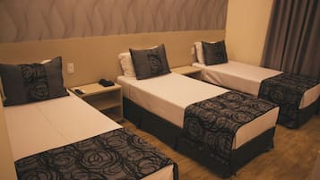Deluxe Triple Room | Minibar, in-room safe, desk, blackout curtains