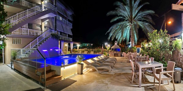 Seasonal outdoor pool, open 8:00 AM to 9:00 PM, pool umbrellas