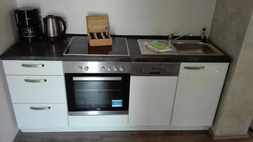 Fridge, stovetop, dishwasher, coffee/tea maker