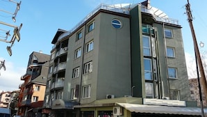 A multi-story building with balconies, large windows, and a flat roof. - Rotasar Hotel (Sofia)