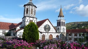 A church with a prominent bell tower and a clock.
