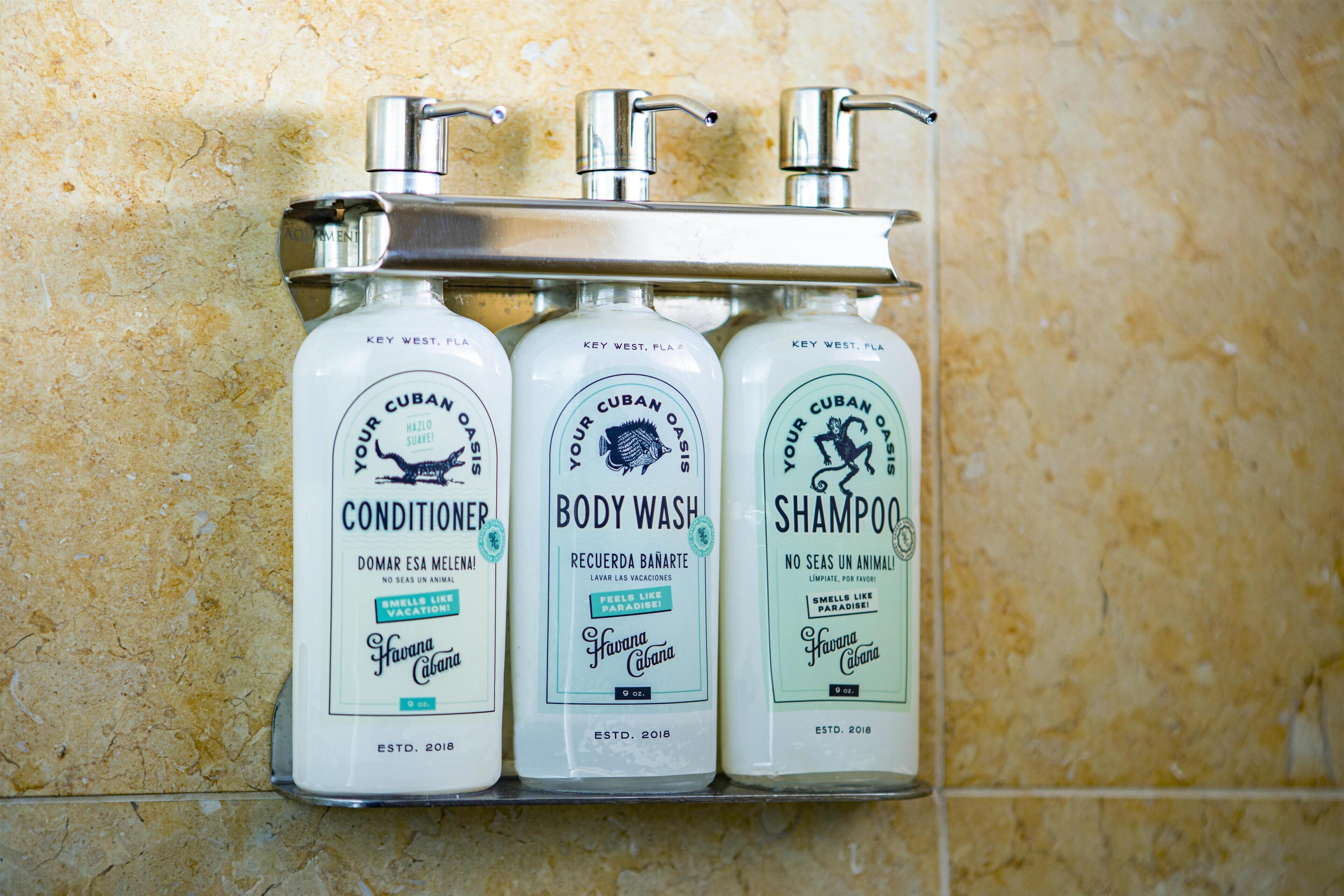 Three bottles of Key West, Fla. Cuban OAS toiletries on a bathroom shelf.