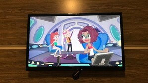 A television displaying an animated scene with characters in a futuristic setting.