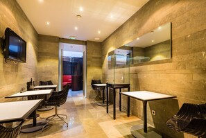 A modern conference room with marble walls, a large mirror, and a TV mounted on the wall. - CMG Tour Eiffel (Paris)