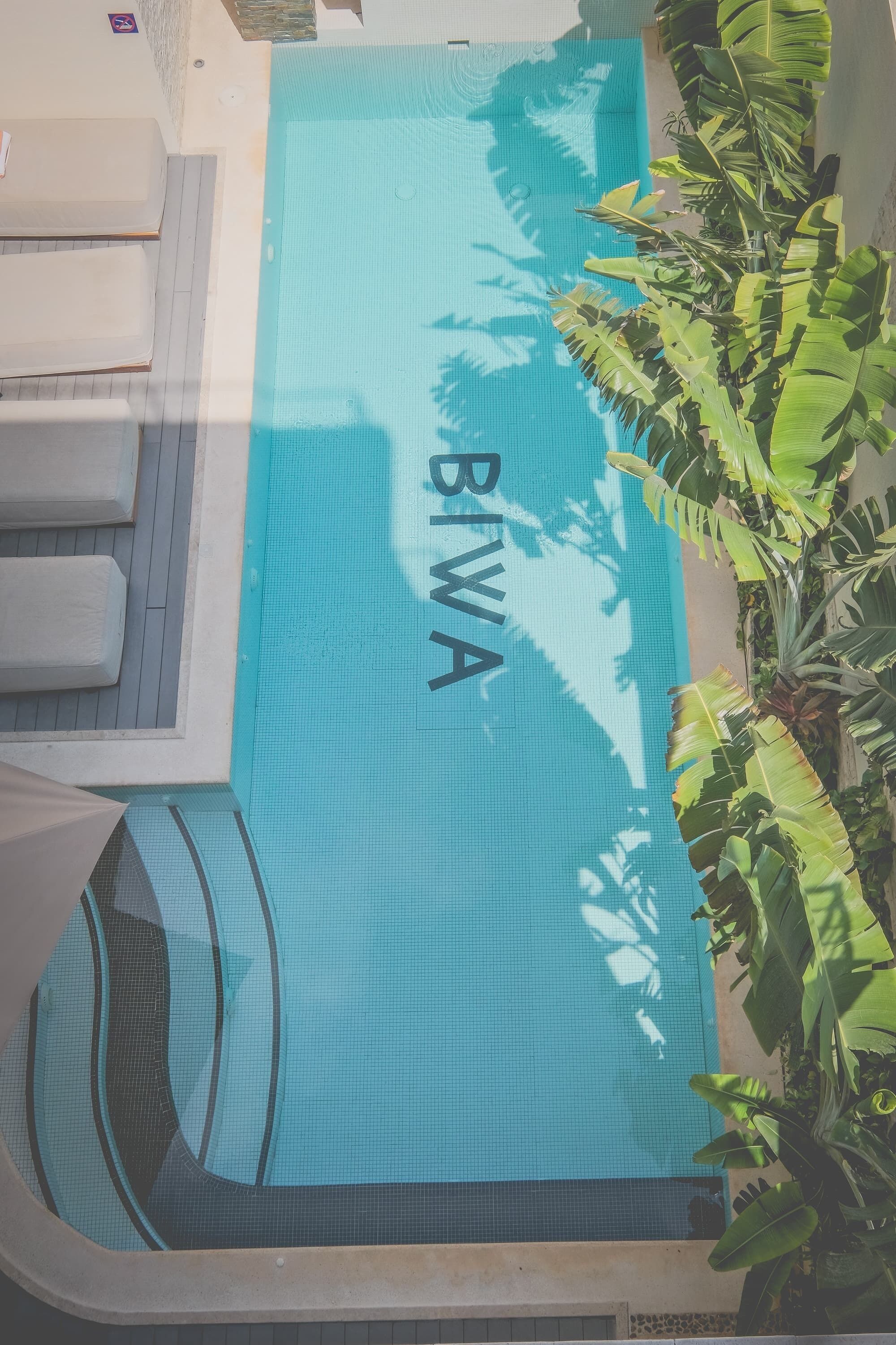 A pool area with a blue surface and the word "BIWA" visible.
