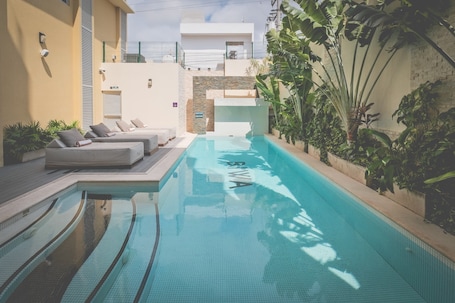 Outdoor pool, open 7:00 AM to 10:00 PM, sun loungers