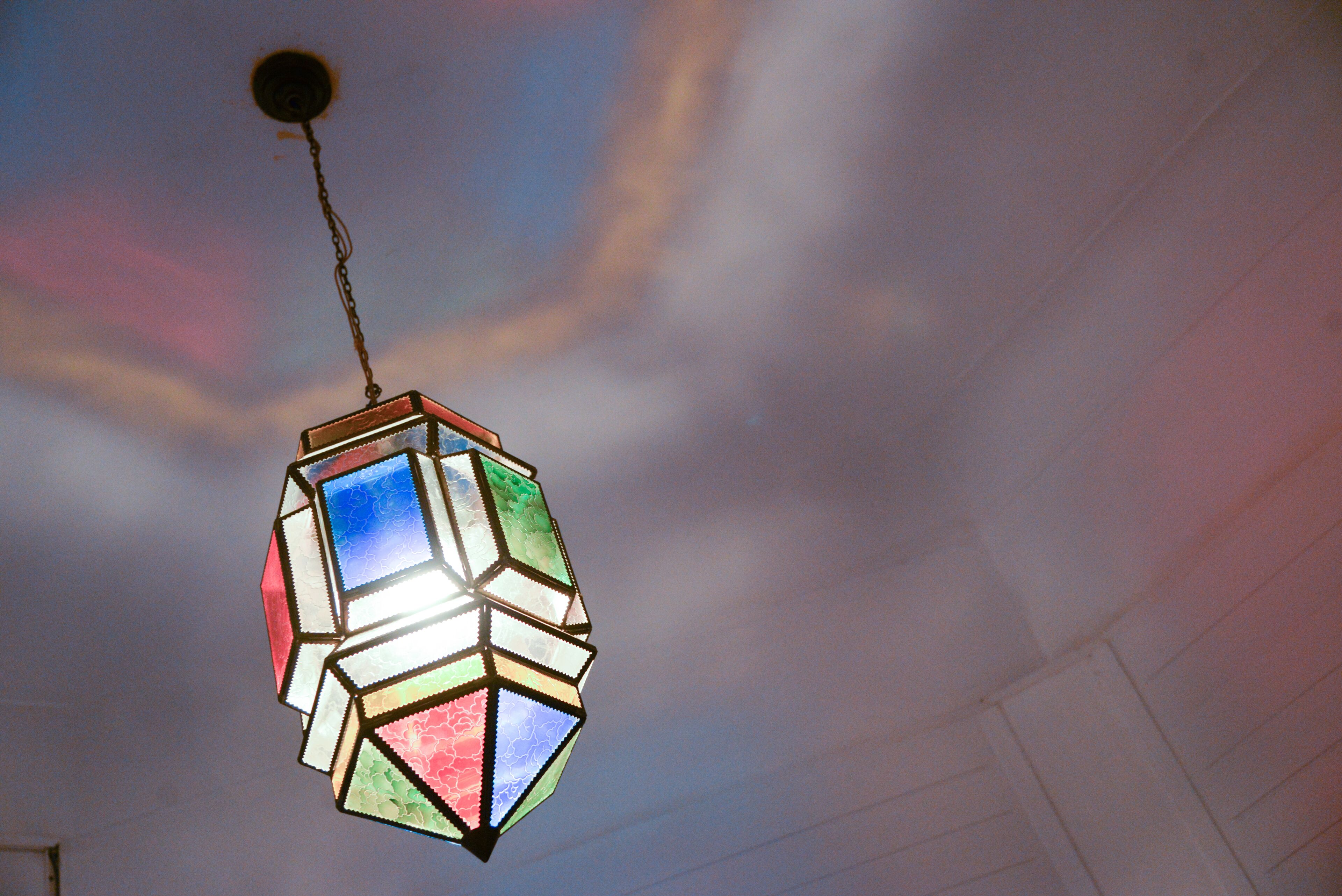 A hanging light fixture with a geometric design.