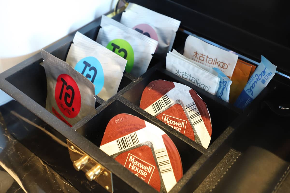 A storage compartment with various items, including bags with visible brand names and logos.
